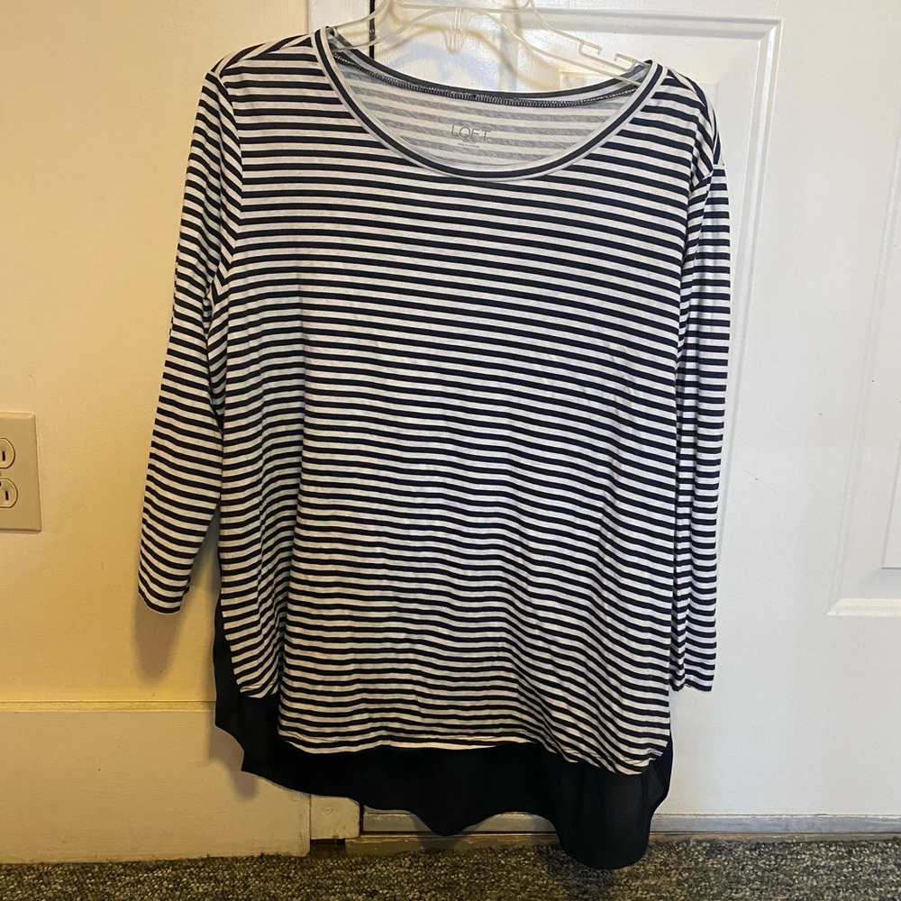 White and dark blue striped 3/4 length sleeve shirt.